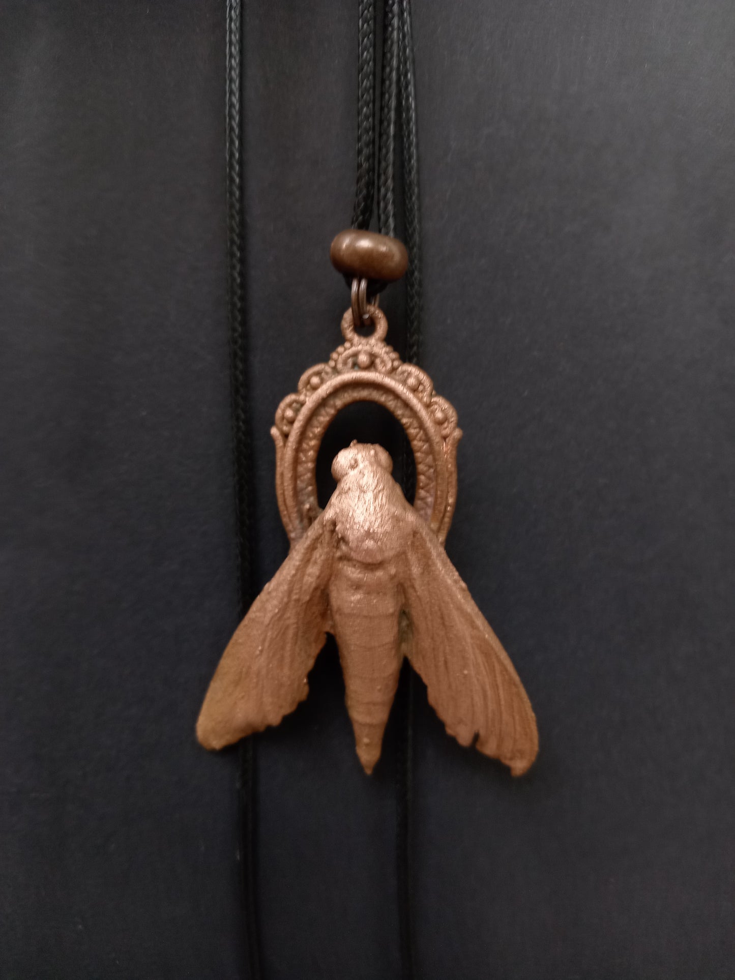Copper moth talisman pendant detail, natural patina finish, ethical handmade jewellery