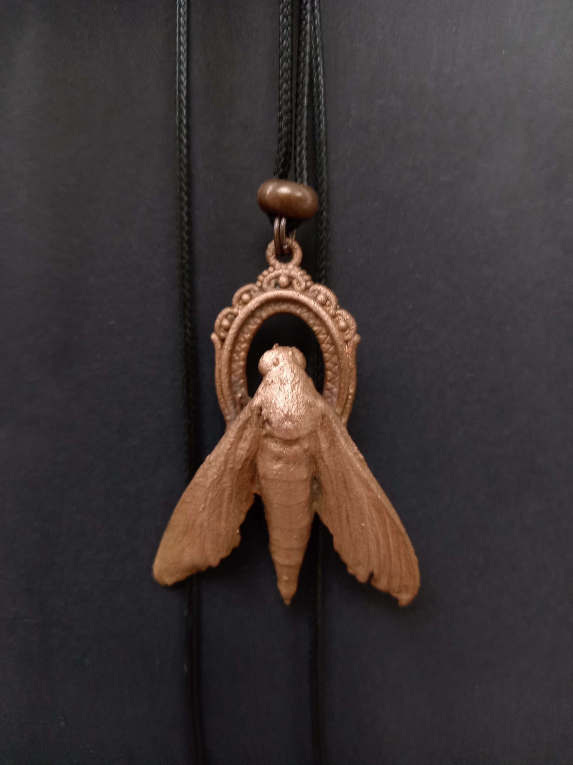 Copper moth talisman pendant detail, natural patina finish, ethical handmade jewellery
